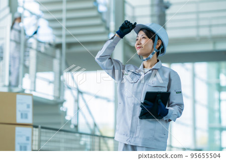A middle-aged woman who manages production in a modern factory 95655504