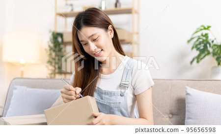 Online selling business, Small business owners are checking inventory in order to prepare them for proper delivery to customers, Online shopping SME entrepreneur, Delivery of goods to consumers. 95656598