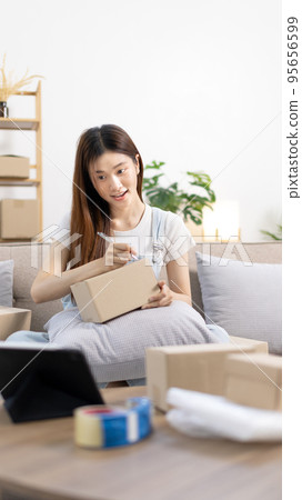 Online selling business, Small business owners are checking inventory in order to prepare them for proper delivery to customers, Online shopping SME entrepreneur, Delivery of goods to consumers. 95656599