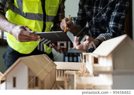 Architect man working with blueprints for architectural plan, engineer sketching a construction project concept Architect man working with blueprints for architectural plan, engineer sketching a construction project concept 95656882
