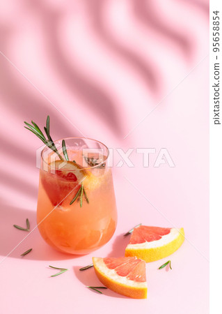 Summer cocktail with grapefruit, rosemary, and ice. 95658854