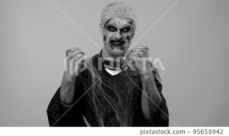Zombie scary Halloween man celebrate success win scream rejoices doing winner hands gesture say Yes Zombie scary Halloween man celebrate success win scream rejoices doing winner hands gesture say Yes 95658942