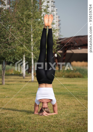 Woman doing stretching exercises outdoors in the morning. Beautiful happy sport fitness model outside on summer spring day. Woman doing stretching exercises outdoors in the morning. Beautiful happy sport fitness model outside on summer spring day. 95659764