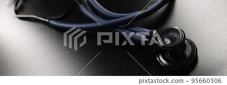 Medical stethoscope placed on dark surface, tool for patient diagnostic Medical stethoscope placed on dark surface, tool for patient diagnostic 95660306