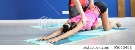 Man partner support woman in stretching on mat, yoga class for health Man partner support woman in stretching on mat, yoga class for health 95660498