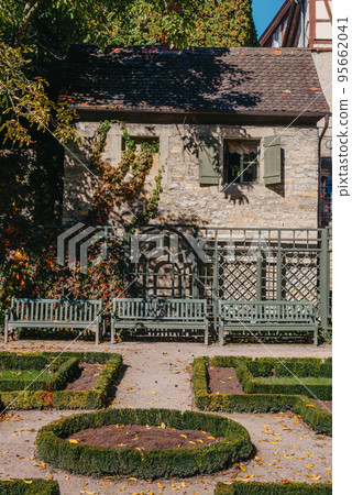 House with nice garden in autumn season. Flowers in the City Park of Bietigheim-Bissingen, Baden-Wuerttemberg, Germany, Europe. Autumn Park and house, nobody, bush and grenery House with nice garden in autumn season. Flowers in the City Park of Bietigheim-Bissingen, Baden-Wuerttemberg, Germany, Europe. Autumn Park and house, nobody, bush and grenery 95662041
