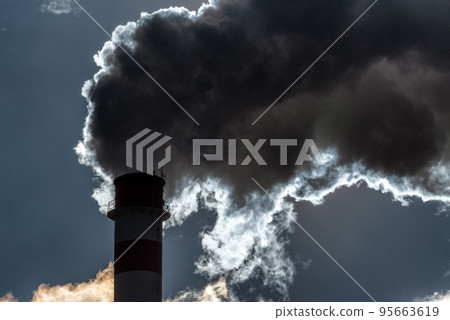 Dark smoke from smokestack against the sky Dark smoke from smokestack against the sky 95663619