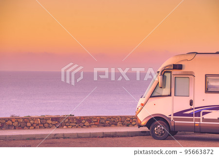 Camper car on coast at sunrise 95663872