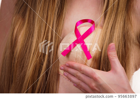 Woman chest in bra, pink cancer ribbon 95663897