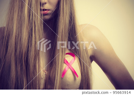 Woman chest in bra, pink cancer ribbon 95663914