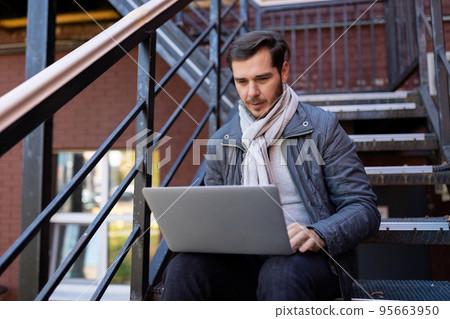 young businessman with laptop working online outside the office, principles and rules of successful 95663950