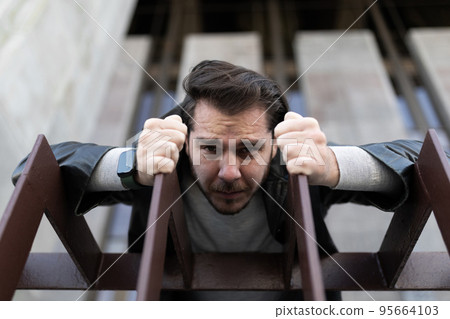 emotional portrait of a depressed man who is trying to get rid of and recover from an illness emotional portrait of a depressed man who is trying to get rid of and recover from an illness 95664103