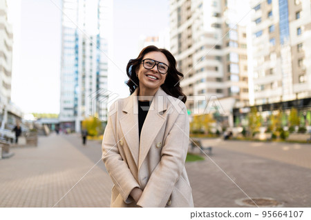 beautiful business woman laughs and looks at the camera with a smile, concept of successful business beautiful business woman laughs and looks at the camera with a smile, concept of successful business 95664107
