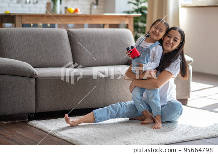 Loving young mother embracing her cute child 95664798