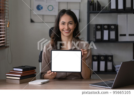 Business woman holding digital tablet show something on display at office. Blank screen for your advertising Business woman holding digital tablet show something on display at office. Blank screen for your advertising 95665105
