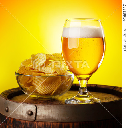 Beer glass on wooden barrel 95665557