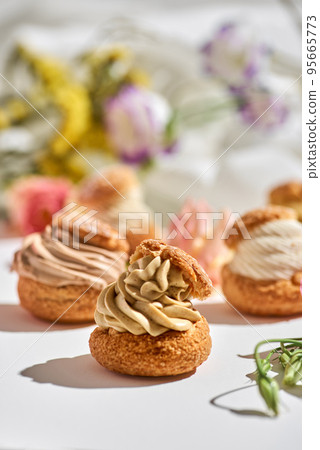 tasty cake shu or eclairs with cream on white background with copy space tasty cake shu or eclairs with cream on white background with copy space 95665773
