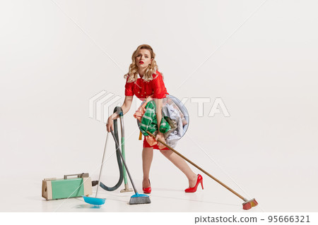 Portrait of beautiful tired woman vacuuming, mopping and washing clothes isolated over white background 95666321