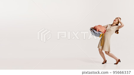 Portrait of young elegant woman washing clothes isolated over white background. Feeling tired 95666337