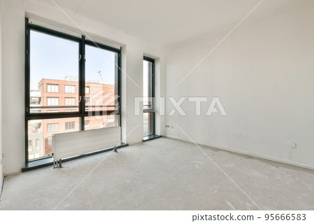 Interior of empty white room with large balcony windows with curtains and wooden parquet floor Interior of empty white room with large balcony windows with curtains and wooden parquet floor 95666583