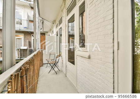 Sitting area in balcony with comfortable furniture around beautiful view Sitting area in balcony with comfortable furniture around beautiful view 95666586
