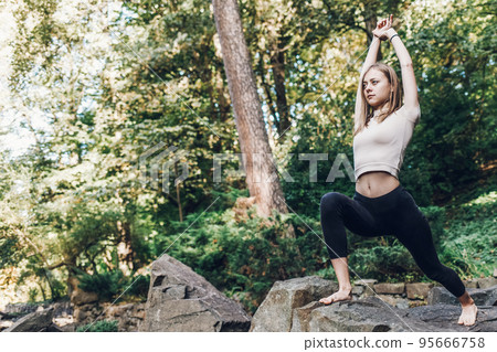 Athleticwoman standing in yoga pose. Yoga exercise outdoor.. Athleticwoman standing in yoga pose. Yoga exercise outdoor.. 95666758