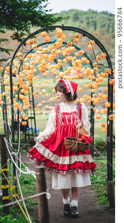 Halloween pumpkin and costumed woman 95666784