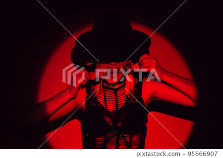 sexy girl in underwear and hat holds handcuffs in teeth. BDSM concept of a submissive woman 95666907