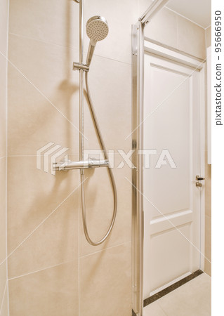 Sink with tap and liquid soap hanging on tiled wall under mirror in contemporary restroom at home Sink with tap and liquid soap hanging on tiled wall under mirror in contemporary restroom at home 95666950