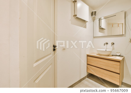 Sink with tap and liquid soap hanging on tiled wall under mirror in contemporary restroom at home Sink with tap and liquid soap hanging on tiled wall under mirror in contemporary restroom at home 95667009