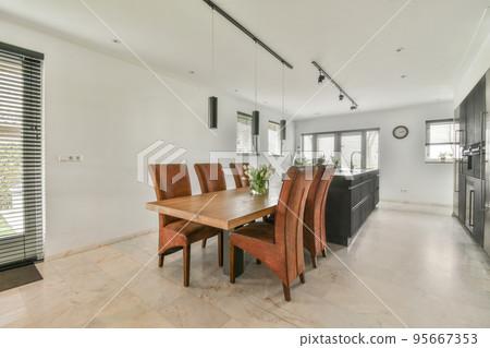 Comfortable bed placed near green wall in modern minimalist style mansard bedroom with windows Comfortable bed placed near green wall in modern minimalist style mansard bedroom with windows 95667353