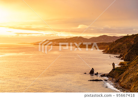 Rocky coast and seaside cliffs at sunset, Spain 95667418