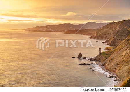 Rocky coast and seaside cliffs at sunset, Spain 95667421