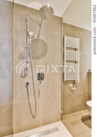 Bathroom with white tiled walls and open shower near sink base cabinet in light Bathroom with white tiled walls and open shower near sink base cabinet in light 95667862