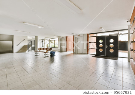 Corridor of contemporary apartment with black closets and opened doorway leading to terrace Corridor of contemporary apartment with black closets and opened doorway leading to terrace 95667921