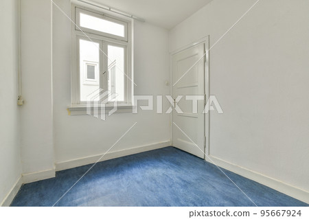 Interior of empty white room with large balcony windows with curtains and wooden parquet floor 95667924