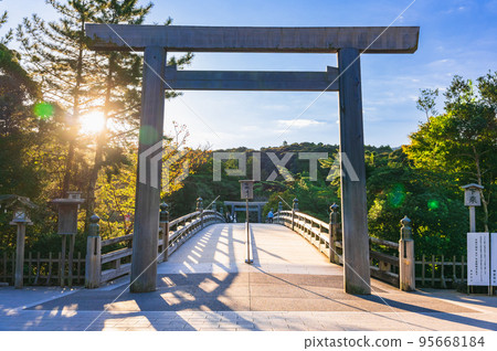 Ise Jingu Inner Shrine Uji Bridge Torii illuminated by the morning sun 95668184