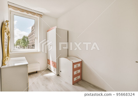 Home interior design of bedroom with bed and wooden wardrobe placed in corner near window in modern apartment Home interior design of bedroom with bed and wooden wardrobe placed in corner near window in modern apartment 95668324