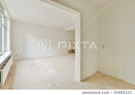 Plastic window and radiator on white wall in empty light room at home Plastic window and radiator on white wall in empty light room at home 95668325