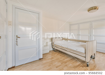 Home interior design of bedroom with bed and wooden wardrobe placed in corner near window in modern apartment Home interior design of bedroom with bed and wooden wardrobe placed in corner near window in modern apartment 95668502