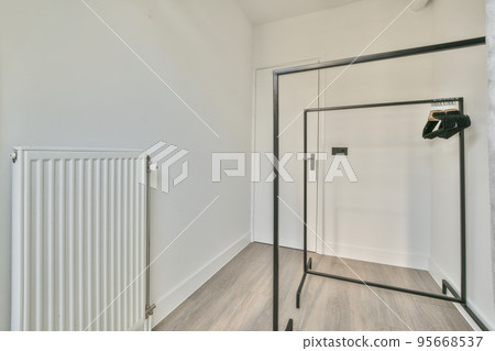 Interior of empty white room with large balcony windows with curtains and wooden parquet floor 95668537