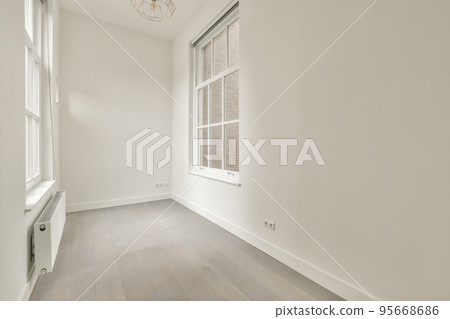 Plastic window and radiator on white wall in empty light room at home Plastic window and radiator on white wall in empty light room at home 95668686