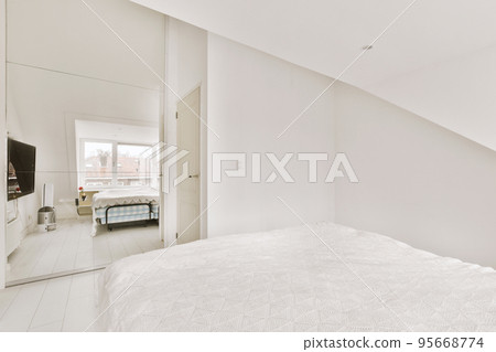 Home interior design of bedroom with bed and wooden wardrobe placed in corner near window in modern apartment Home interior design of bedroom with bed and wooden wardrobe placed in corner near window in modern apartment 95668774