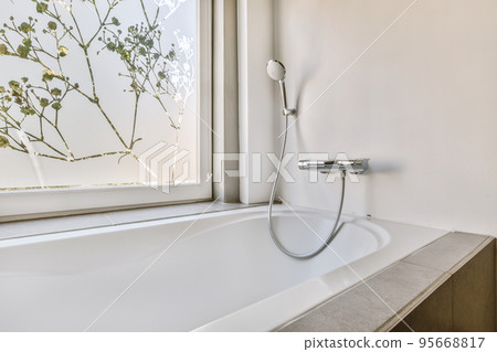 Flush toilet located between sink and shower in small tiled bathroom of contemporary apartment Flush toilet located between sink and shower in small tiled bathroom of contemporary apartment 95668817