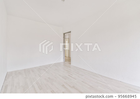 Interior of empty white room with large balcony windows with curtains and wooden parquet floor 95668945