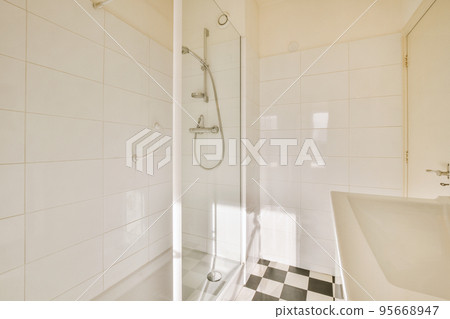 Interior of contemporary bathroom with shower and sink in minimal style in flat 95668947