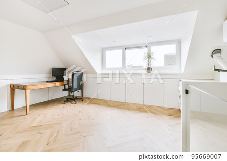 Comfortable chair placed near desk with computer monitors and whiteboard in light workplace in modern apartment Comfortable chair placed near desk with computer monitors and whiteboard in light workplace in modern apartment 95669007