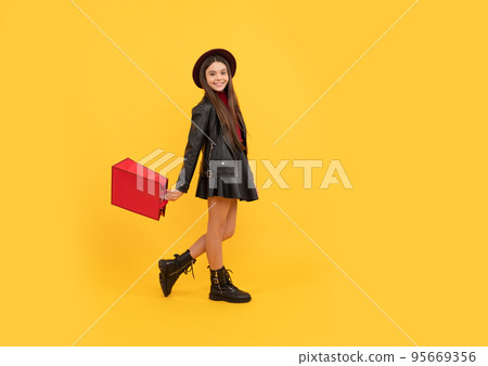 cheerful stylish teen child shopping. kid in hat hold shopping bag. autumn season trends. 95669356