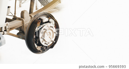 Inside system of the car drum brake, car without a wheel for brake inspection in auto repair garage Inside system of the car drum brake, car without a wheel for brake inspection in auto repair garage 95669393