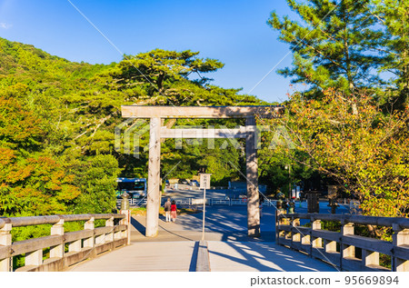 Ise Jingu Inner Shrine Uji Bridge Torii illuminated by the morning sun 95669894
